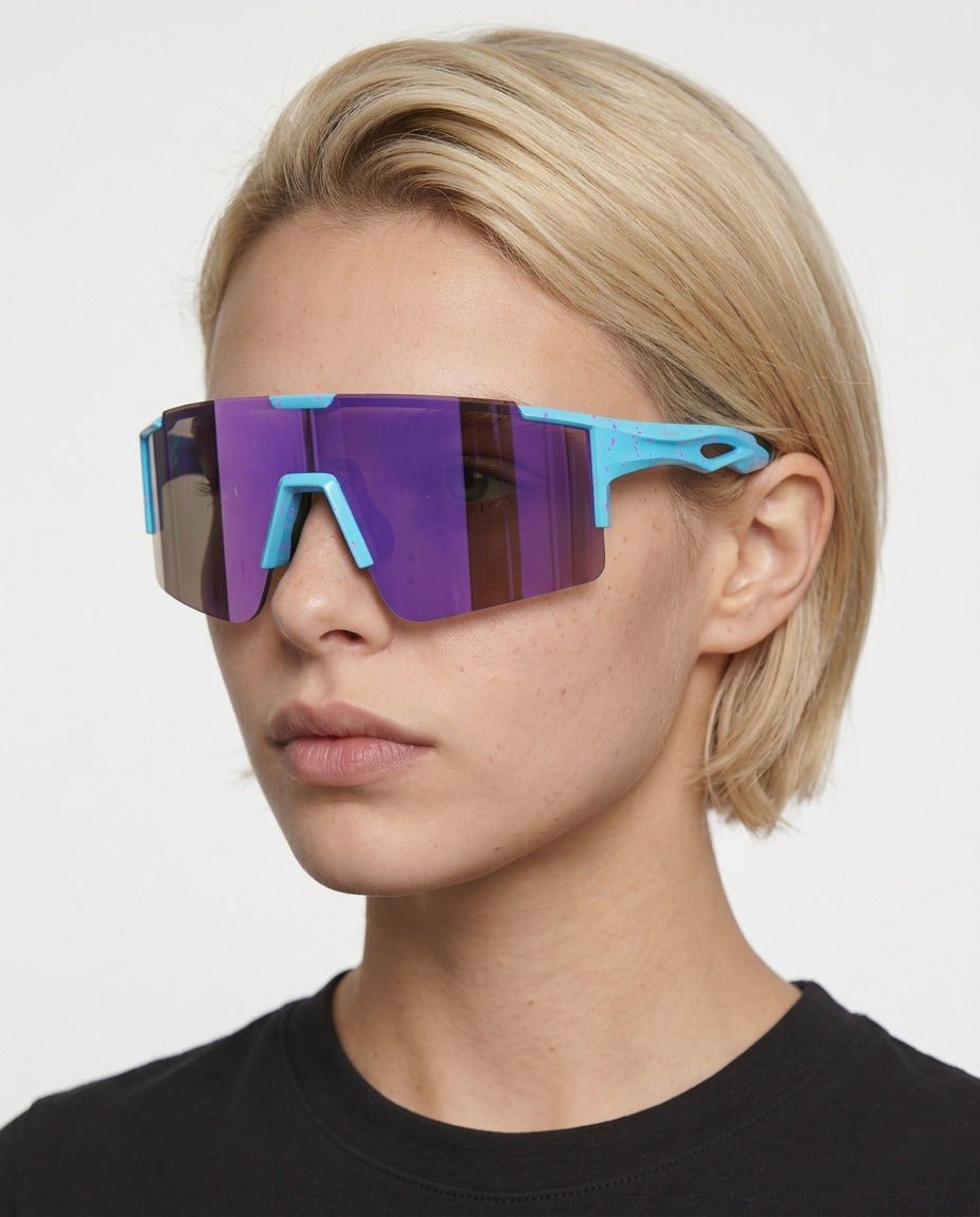 Dial Up sport shield sunglasses in Purple / White, purple lens on white frame, worn by a woman, front view