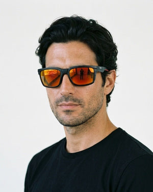 Flux sport wrap sunglasses in Orange / Black, orange lens on black frame, worn by a man, front view