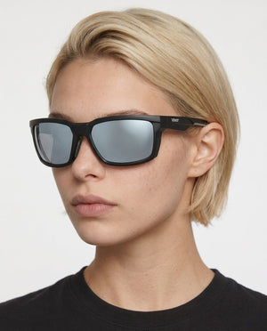 Flux sport wrap sunglasses in Grey / Black, grey lens on black frame, worn by a woman, front view