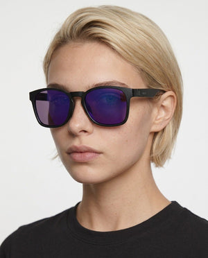 Loft square sunglasses in Purple / Black, purple lens on black frame, worn by a woman, front view