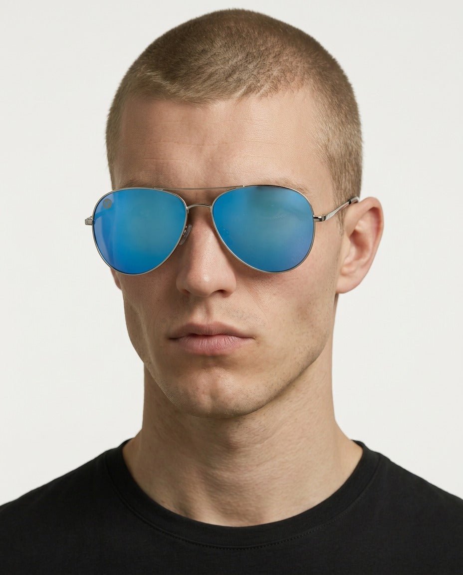 Nexus metal aviator sunglasses in Blue / Silver, blue lens on silver frame, worn by a man, front view