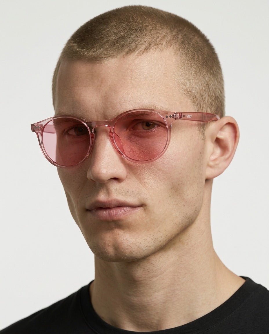 Onyx round retro sunglasses in Pink / Clear Pink, pink lens on clear pink frame, worn by a man, front view