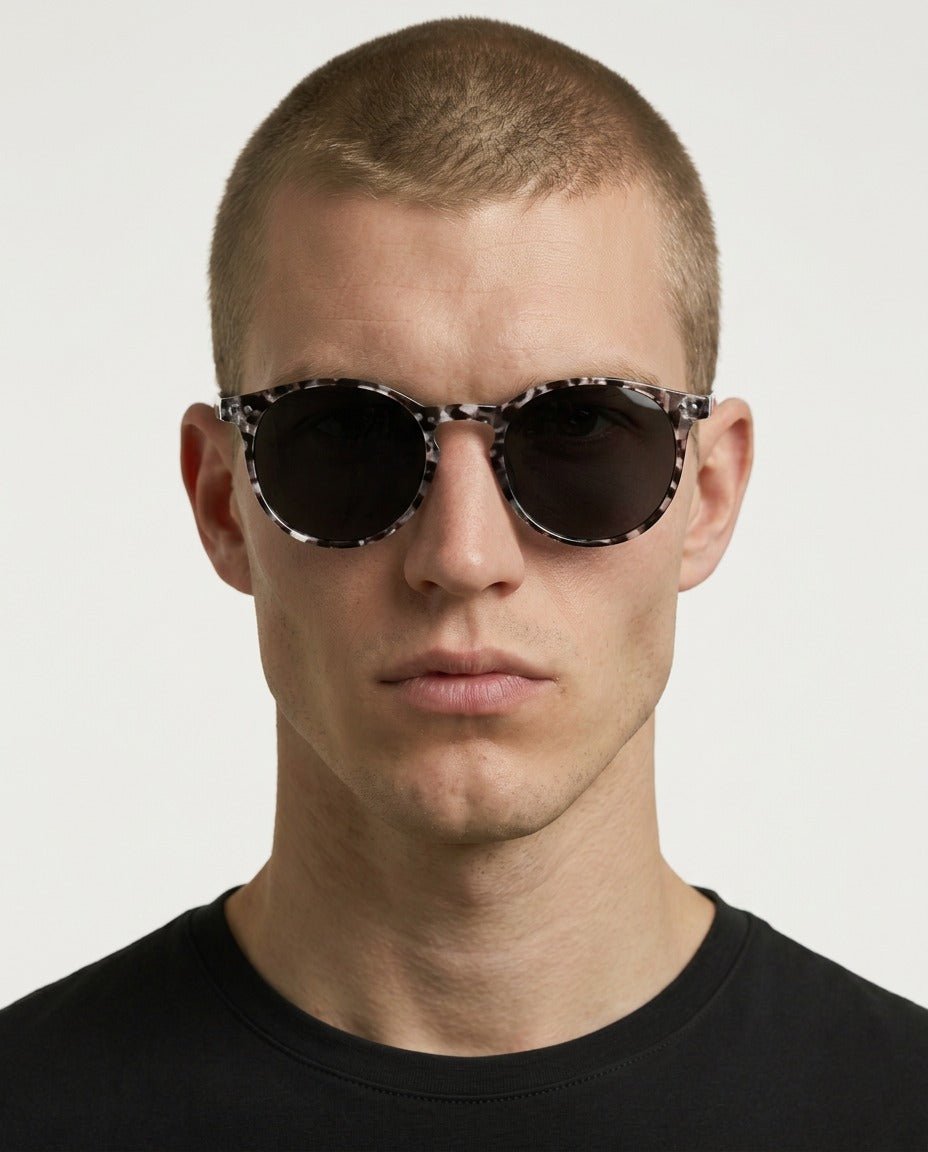 Onyx round retro sunglasses in Black / White Tortoise, black lens on white tortoise frame, worn by a man, front view