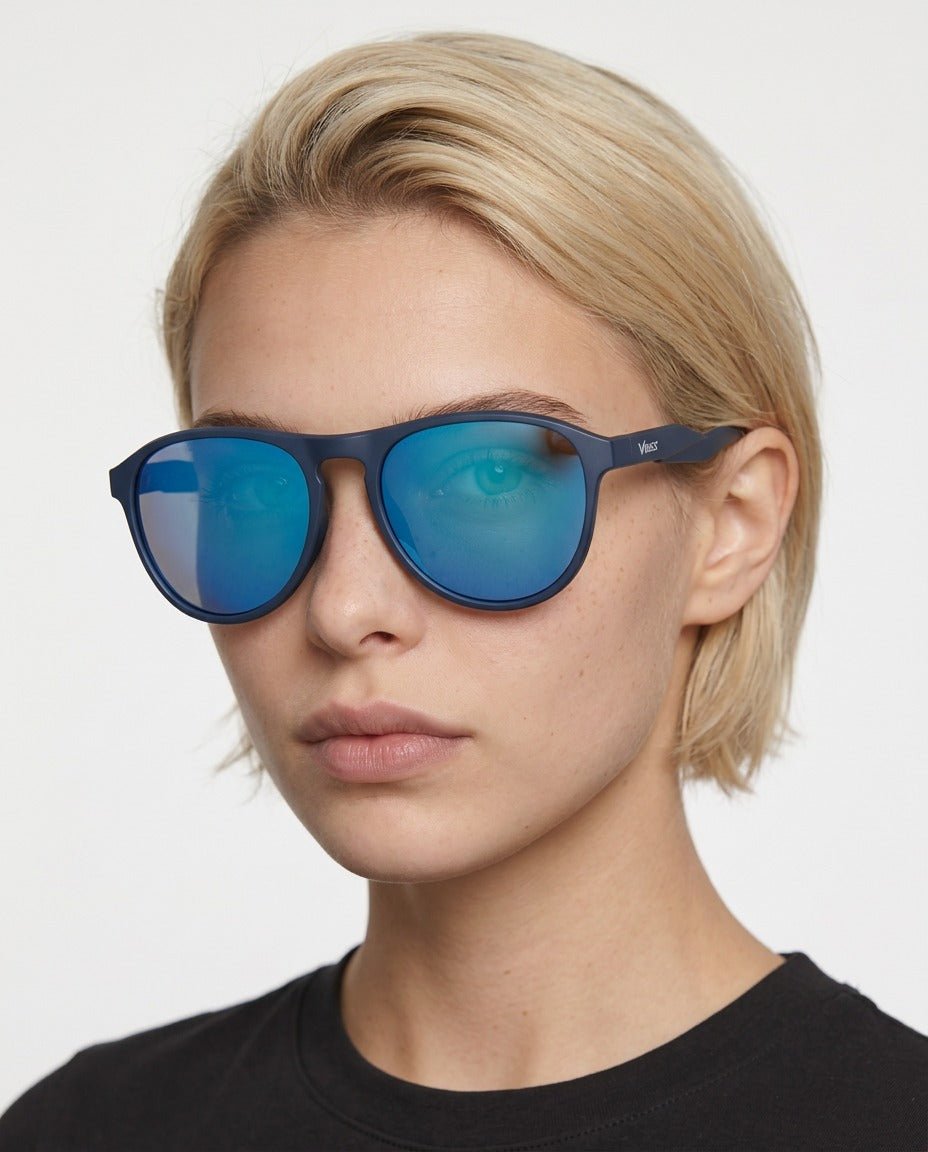 Orbit rounded aviator sunglasses in Blue / Blue, blue lens on blue frame, worn by a woman, front view