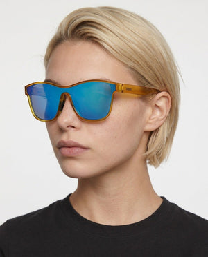 Radar performance wrap sunglasses in Blue / Yellow, blue lens on yellow frame, worn by a woman, front view