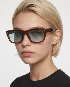 Riviera rectangle acetate sunglasses in Light Blue / Brown, light blue lens on brown frame, worn by a woman, front view