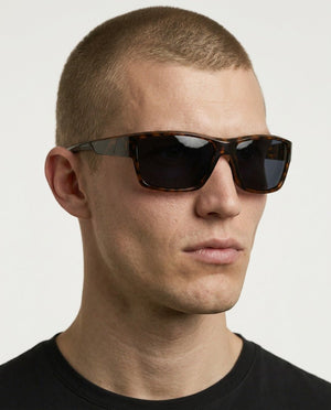 Specter slim wrap sunglasses in Black / Tortoise, black lens on tortoise frame, worn by a man, front view