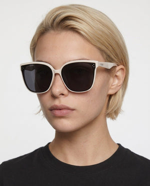 Vesper oversized square sunglasses in Black / Cream, black lens on cream frame, worn by a woman, front view