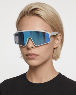 Brooklyn sport shield sunglasses in Blue / White, blue lens on white frame, worn by a woman, front view