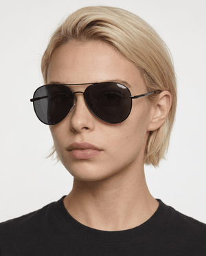 Nexus metal aviator sunglasses in Grey / Black, grey lens on black frame, worn by a woman, front view