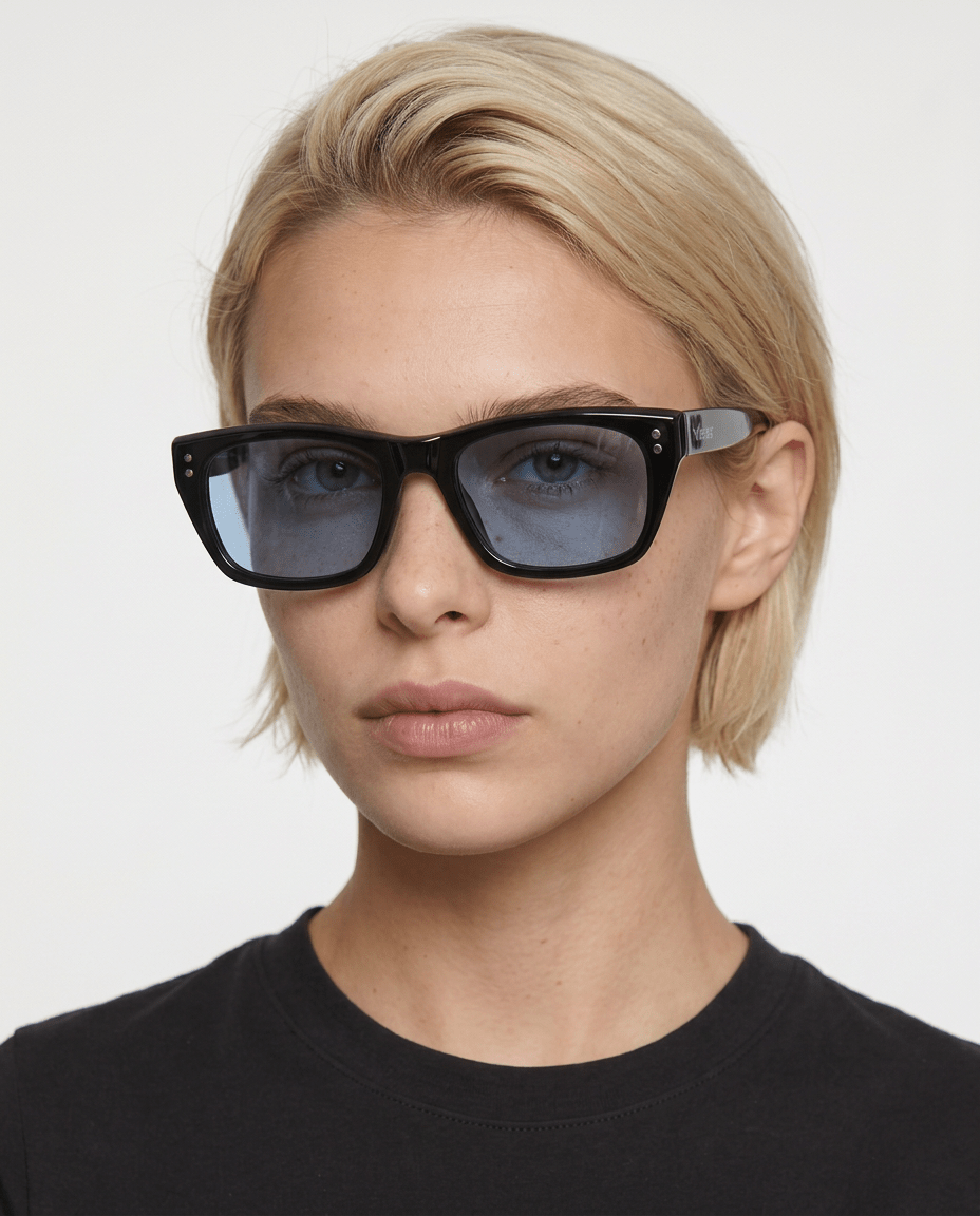 Riviera rectangle acetate sunglasses in Blue / Black, blue lens on black frame, worn by a woman, front view