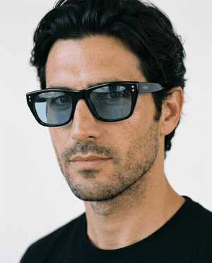 Riviera rectangle acetate sunglasses in Blue / Black, blue lens on black frame, worn by a man, front view