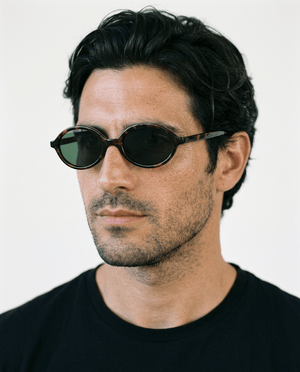 Mojave slim oval metal sunglasses in Green / Tortoise, green lens on tortoise frame, worn by a man, front view