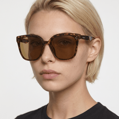 Vesper oversized square sunglasses in Tea / Tortoise, tea lens on tortoise frame, worn by a woman, front view