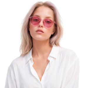 Onyx round retro sunglasses in Pink / Clear Pink, pink lens on clear pink frame, worn by a woman, front view